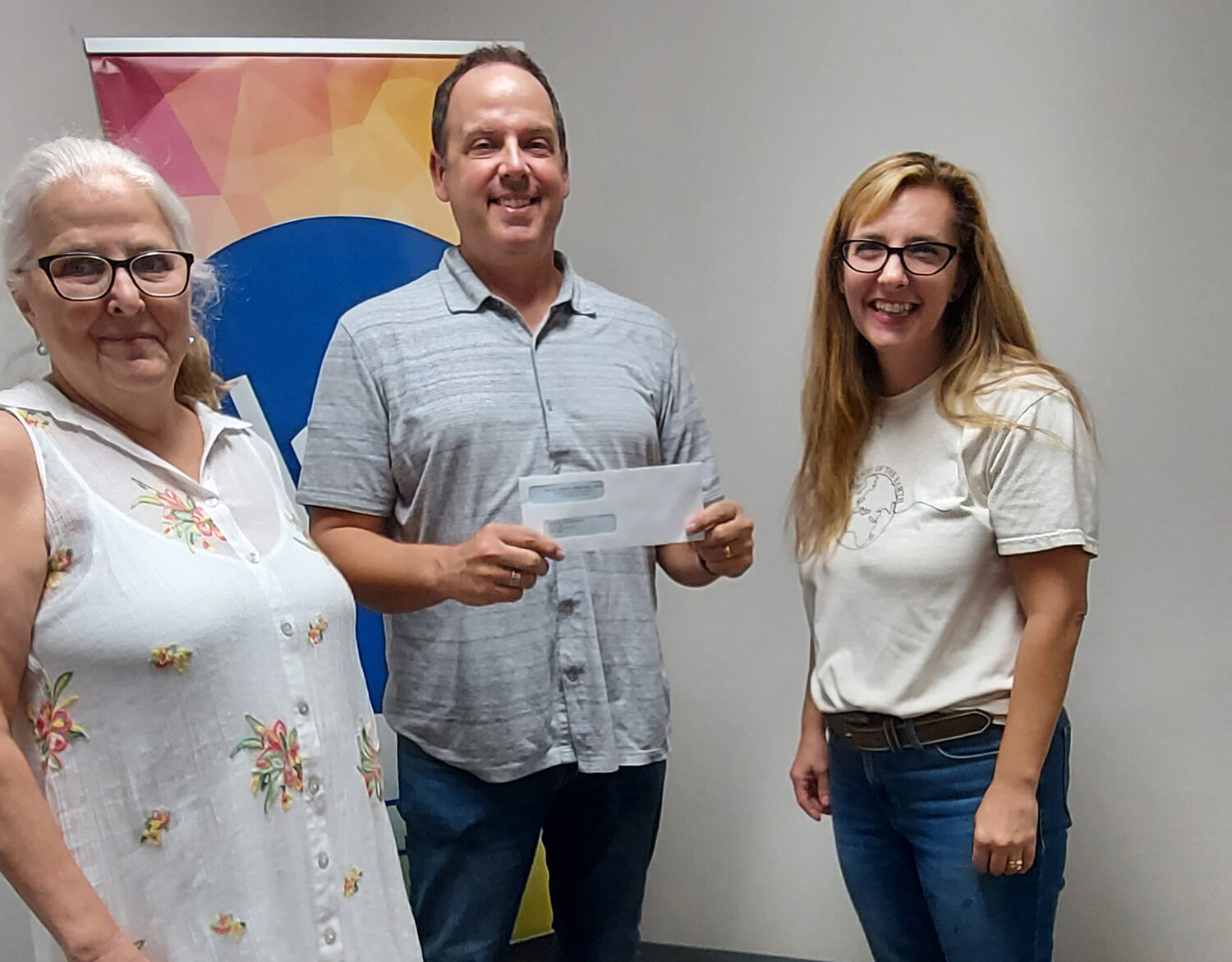 Lauren Sullens, Georgia WMU president, presents a grant to Scott Baker, pastor of First Baptist Church of Richmond Hill, and Dianne Drane, left, director of the church's food ministry. (Photo/Georgia WMU)