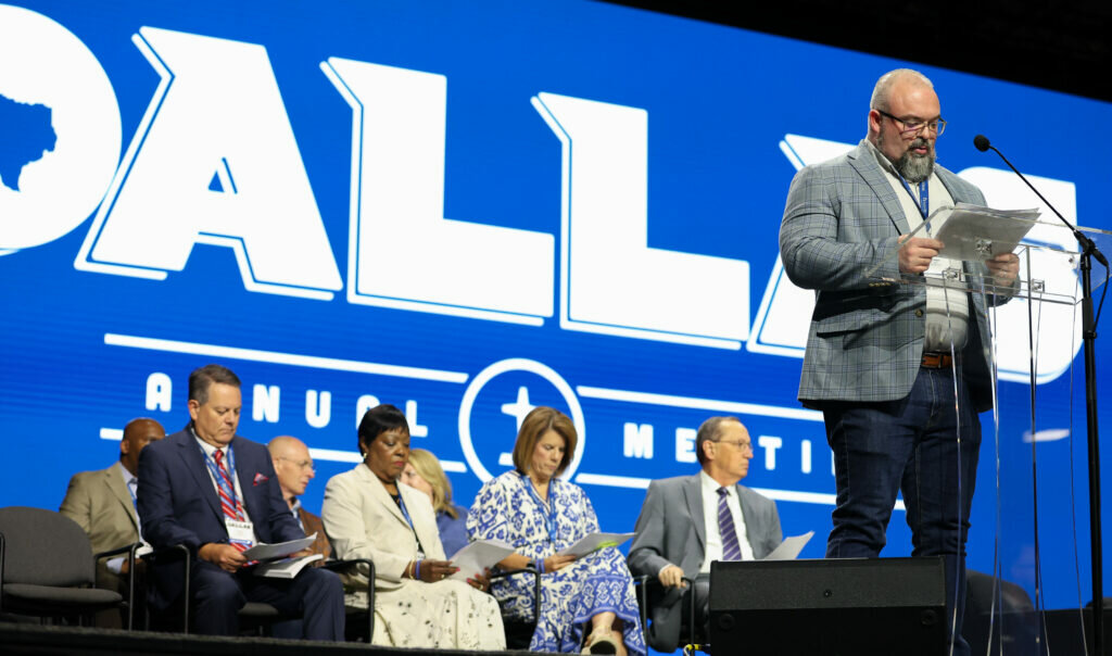 Adam Wyatt, chair of the SBC Executive Committee’s Committee on Convention Finances and Stewardship Development, speaks as messengers approve the 2025-26 Cooperative Program allocation budget and additional business items during the 2025 SBC Annual Meeting in Dallas. (Baptist Press/Sonya Singh)