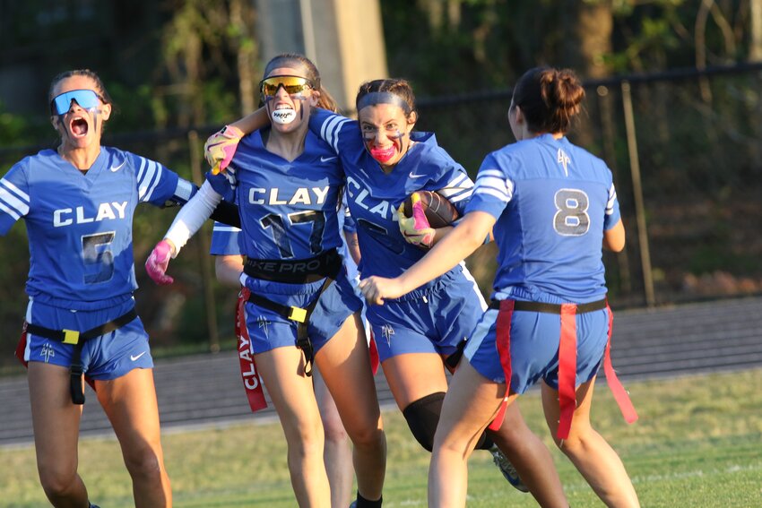 Clay High defensive player Tatum Waugh, right, gets congrats from teammates Kirra Dodson and Cora Parker after game sealing interception in Blue Devils 7-6 district championship win over Ridgeview on Thursday.