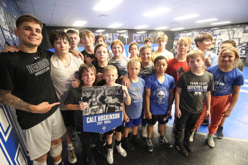 Clay High state champion wrestler Cale Hoskinson mentored a room full of young wrestlers in the same room that he was mentored in to become a state champion.