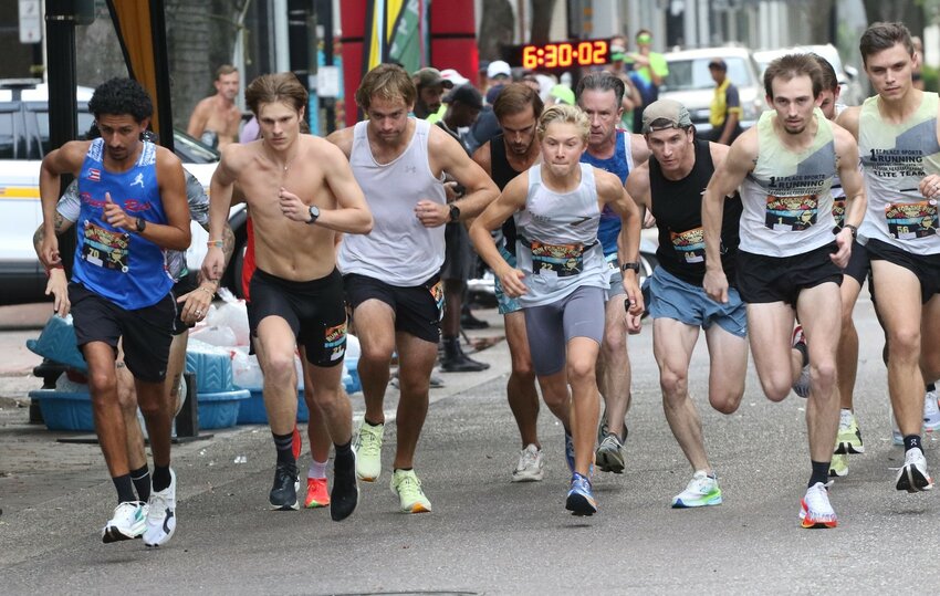 Former Fleming Island High School runners Graham Myers, shirtless on left, and Luke Klingenberg, in white, take off from start of Run for the Pies 5Km elite race held Saturday, June 7 in downtown Jacksonville. Myers finished second with Klingenberg 15th.