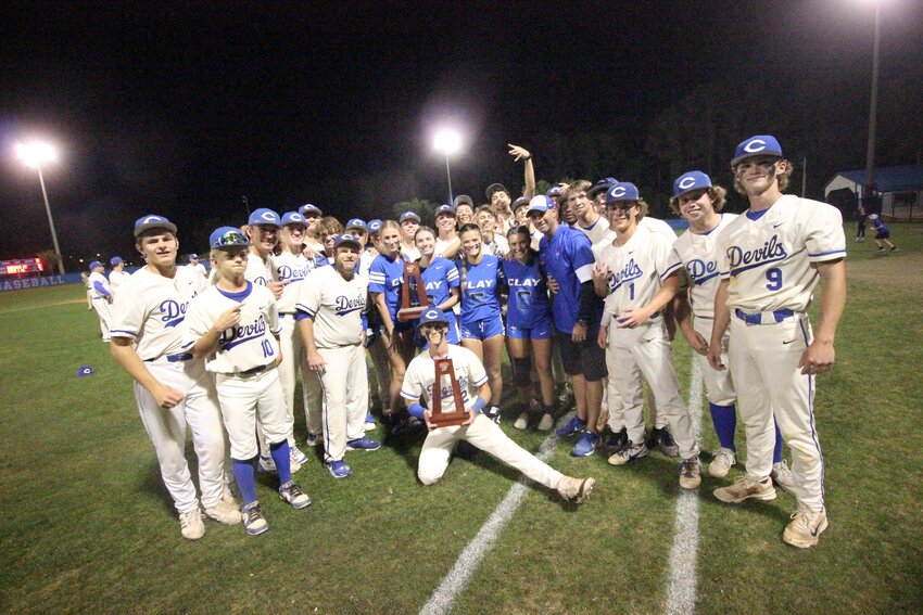 Clay High Scbhool had a banner title night on Thursday, April 17 with the baseball team winning a 7-3 district title over Baker County while, in the hour before baseball, the girls flag football team held on to defeat Ridgeview 7-6 for their district title. Both teams, pictured here with their trophies, advance to region playoff games this week.