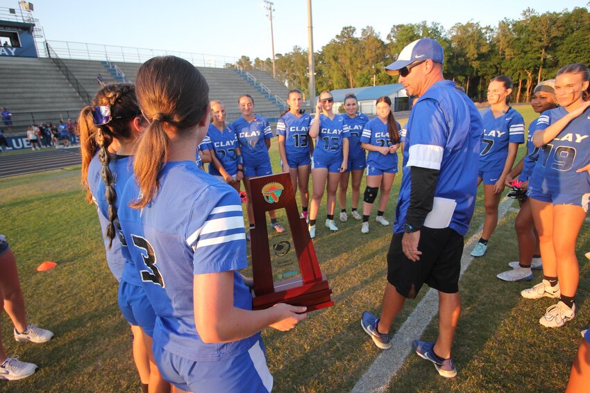 Clay High dad and daughter, coach Jared Moses, right, and his quarterback Teaghan Moses, with trophy, survived tough and thrilling 7-6 win over Ridgeview.