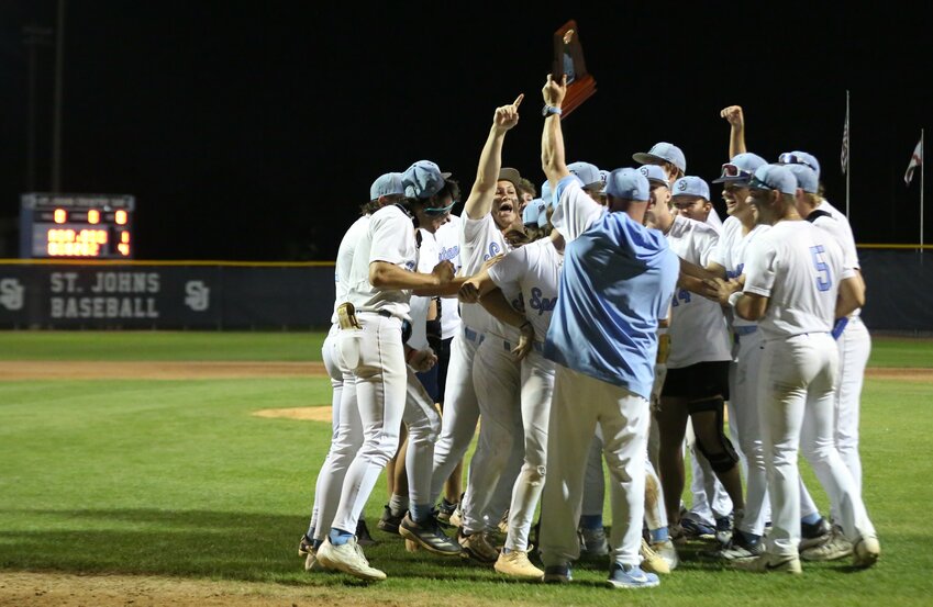 St. Johns Country Day School's baseball team celebrates district title trophy after 4-1 win over St. Joseph's Academy. Spartans to host Covenant School of Jacksonville in region three-game series that starts Monday, April 21.