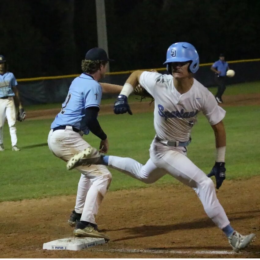 St. Johns batter T.J. Sunderhaus outsprints ball headed to University Christian first baseman in seventh inning with score at 7-5.