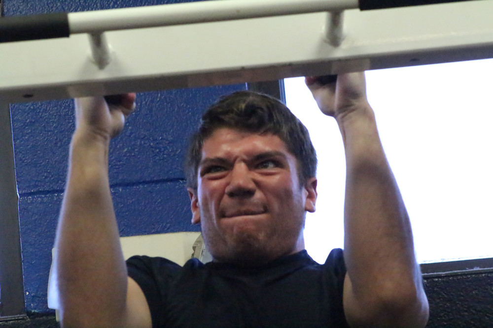 Ridgeview High linebacker Noah Hearn muscles up with pull ups in the final summer session of conditioning before the August 6 start of football practices with pads and the 2016 season. Season openers are set for August 26. See more Ridgeview photos, page 32.
