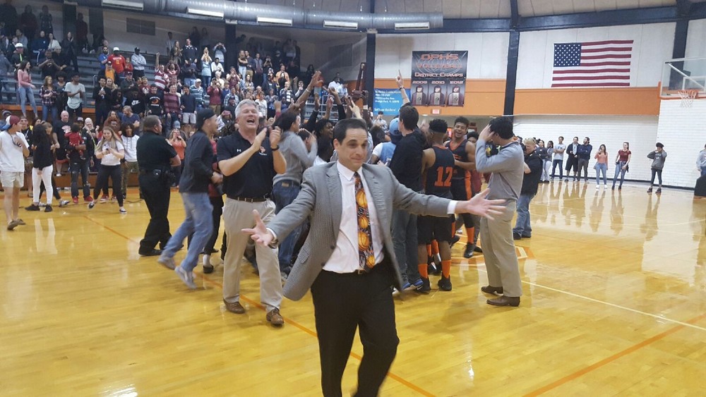 Orange park basketball coach Derek Kurnitsky is all smiles after Raiders beat Baker county 60-52 in district 4-6A final. Raiders are only county team in state playoffs.