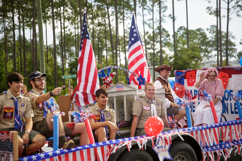 Photo by KILE BREWER  Members of local scouting groups sit on a float and throw candy to parade attendees during this year's Middleburg Fourth of July Parade.