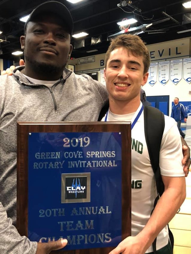 Paul James &quot;PJ&quot; Cobbert, left, stands with his two-time state champion Briar Jackson after the Fleming Island High team won the Clay Rotary.