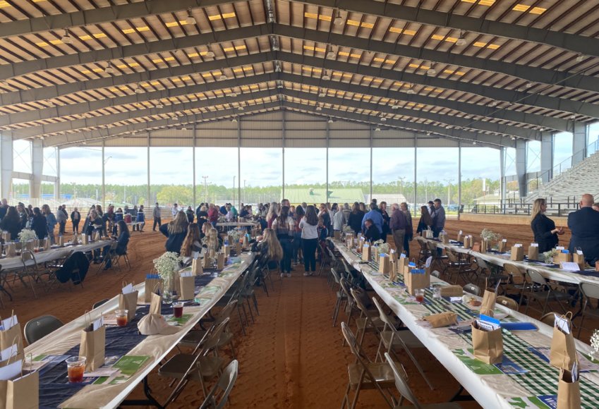 A large line is formed as Clay County residents seek to fill their hungry stomachs. The menu from Cowboy'z Bar-B-Q &amp; Catering in Archer Florida for the event featured pulled chicken with three kinds of barbecue sauce, macaroni and cheese, garden salad and a roll.