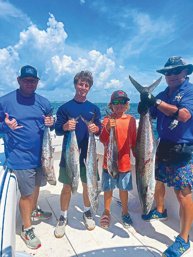 Kingfish tournament media day participants, from left, Kevin Lapthorn,  Ryan Lapthorn, captain mate Brody Rose, 9,  and Clay Today Sports Editor Randy Lefko show off their catches of the day on the boat Cherokee Rose Captained by Lyle Rose of Hilliard.