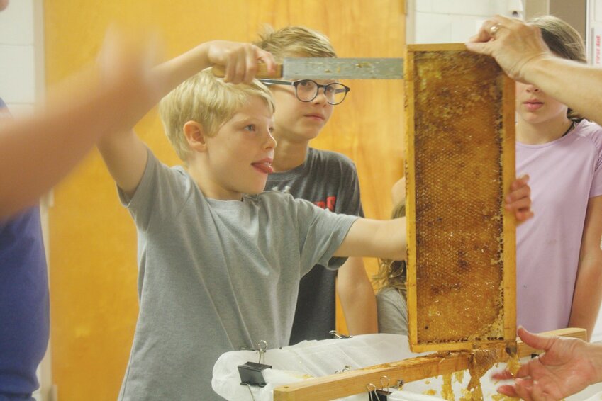 The group has been learning about bees all summer, but during their last meeting, the Stingers could finally put their lessons into practice by going through honey production stations.