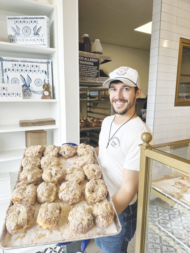 Store manager David V. showed off a tray of freshly created &ldquo;doughnuts&rdquo; at the Fleming Island store. In addition to offering unique pastries and coffee, Parlor Doughnuts has a comfortable dining room.