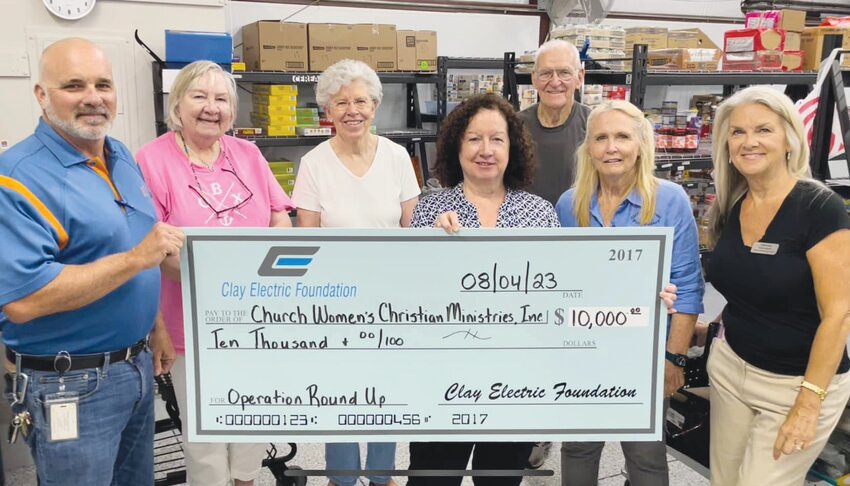 Steve Hollingsworth, left, from Clay Electric Cooperative&rsquo;s Orange Park office delivered a &ldquo;big&rdquo; donation of $10,000 to The Clothes Closet and Food Pantry in Orange Park to bolster the nutritional needs of valued customers.