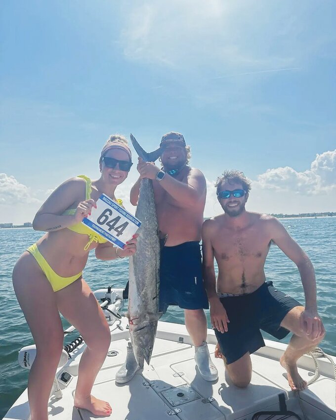 Laura Baylor shows off her first-place Lady Angler 34 lb kingfish caught at the Nassau sport fishing association 40th annual Kingfish tournament. Baylor, here with Robert Vogt, former St John&rsquo;s Country Day Superstar football player, caught the fish on a downrigger using a ribbon fish.