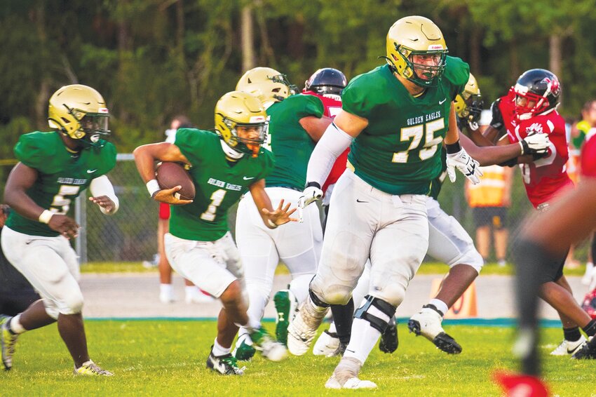 Fleming Island senior tackle Braden Cunningham, No. 75, is a massive figure downfield as he leads quarterback Cibastian Broughton downfield in the Golden Eagles' preseason win over Westside.