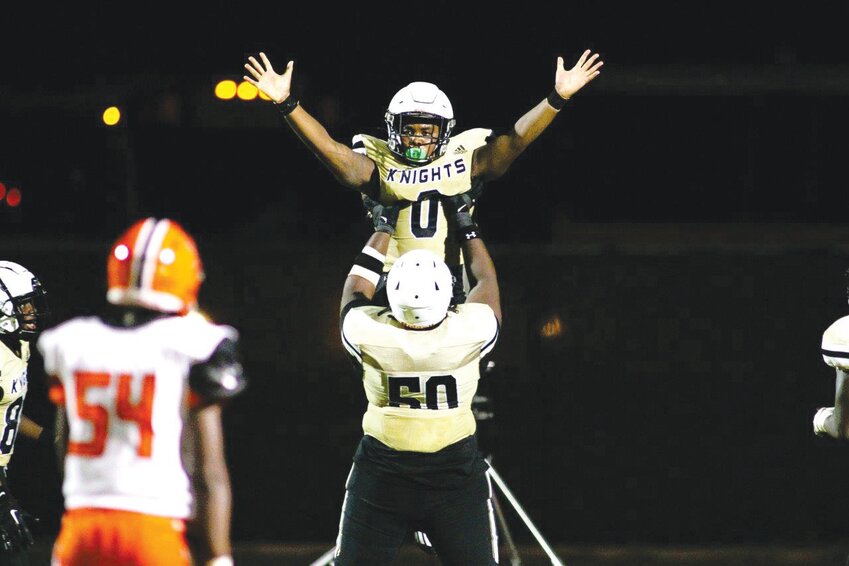 Oakleaf High running back Chris Foy II gets a lift from a teammate after scoring in Knights' 42-0 win over Orange Park.