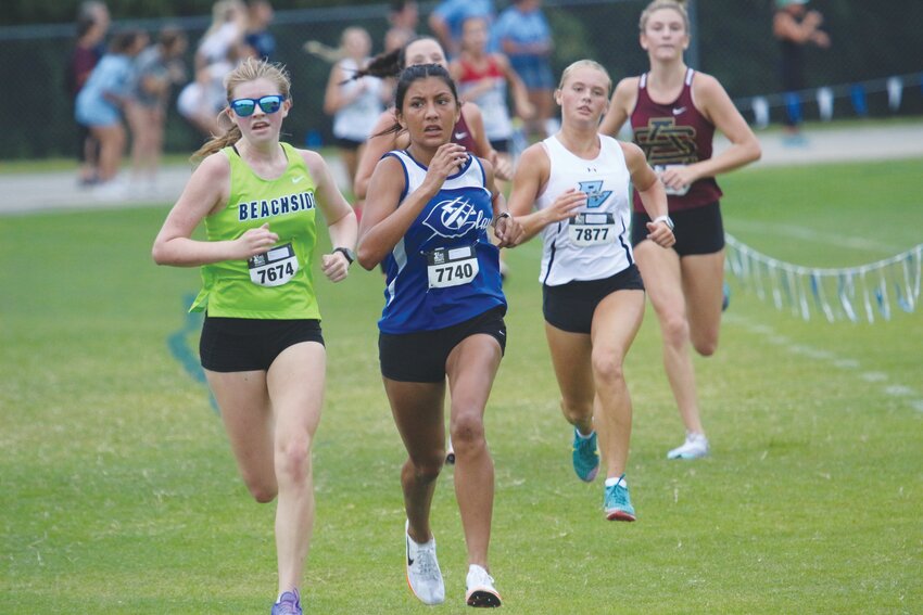 Clay High cross country runner Erika Martinez battles with sunglass-clad Lilly Potts of Beachside High as both runners stride to the finish line of the Bob Hans Memorial Cross Country Invitational held Saturday at Ridgeview High School.