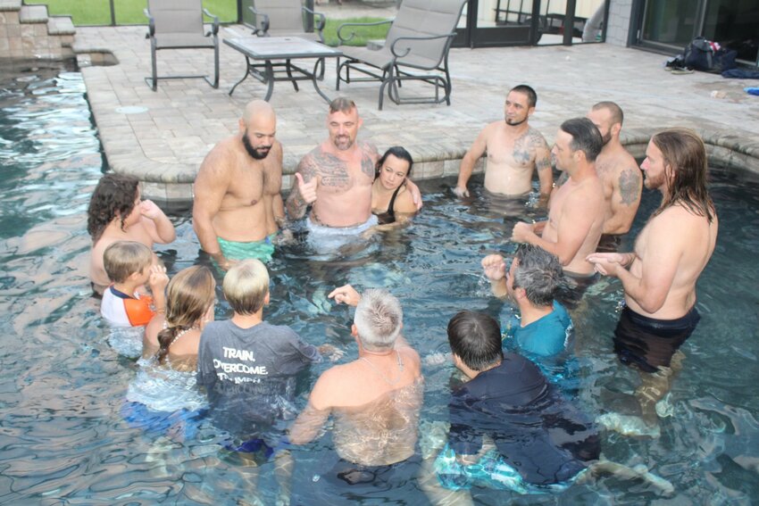 Raylan Heck, center (with wife), founder and CEO of Warrior&rsquo;s Peace, teaches the group a pool lesson on balancing control and surrender to respond rather than overreact to issues during an early-morning session.