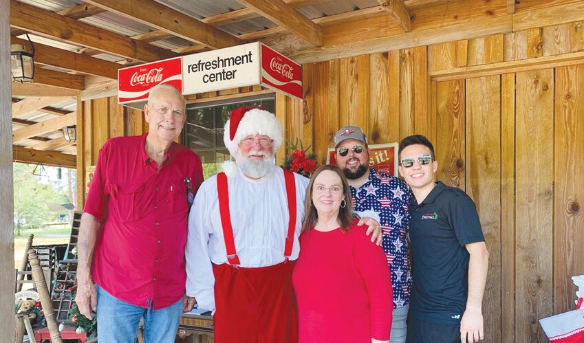 Founder Matthew Mitchell, right, the Elrod family and volunteers began preparing the property for &ldquo;A Country Christmas&rdquo; on Saturday, which will feature more than one million lights.