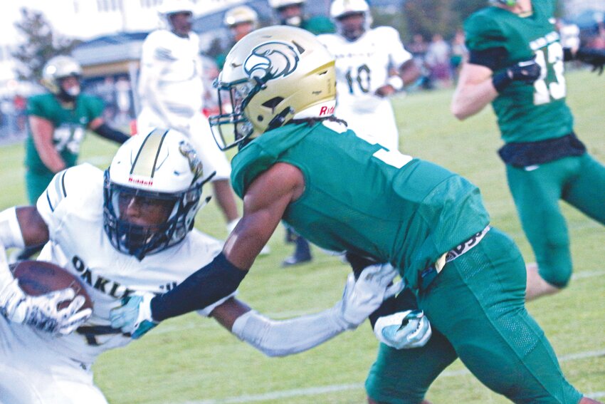 Oakeaf High defensive back Jordin Pryce, in white, steals end zone pass attempt to Fleming Island wide receiver Trace Burney in first-half action of Knights&rsquo; 24-14 district win Friday night.
