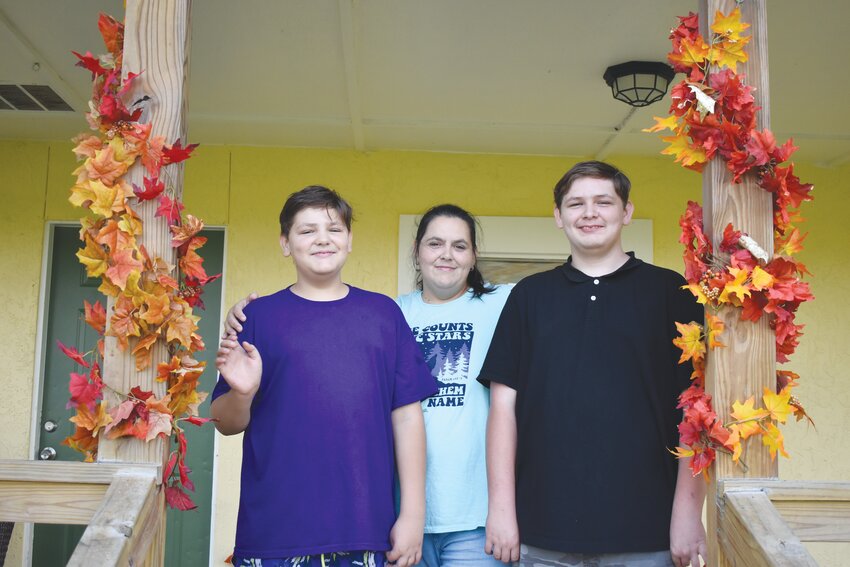 From left, Joshua, Crystal and Matthew Chisholm now have a home in Green Cove Springs. True Vine Fellowship, Penney Retirement Center, Breaking Bread Ministry and Orange Park United Methodist Church James Boys all banded to help the family who lost their home and were forced to live in a shed or car. True Vine&rsquo;s Pastor John Sanders gave the family keys to their home.
