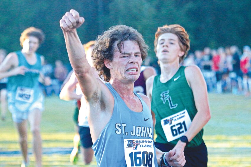 St. Johns CountryDay School senior runner Richard Nichols exalts his effort with best-ever finish and time at Bale and Trail Cross Country at Bartram Trail.