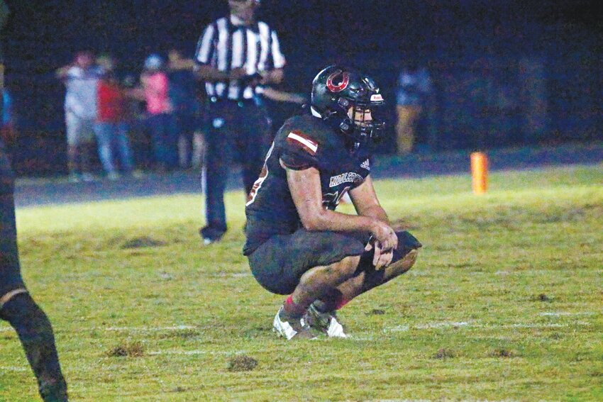 Middleburg High linebacker Austin Cruce contemplates the result of his Broncos&rsquo; 17-6 district loss to Columbia on a wet, mucky field.