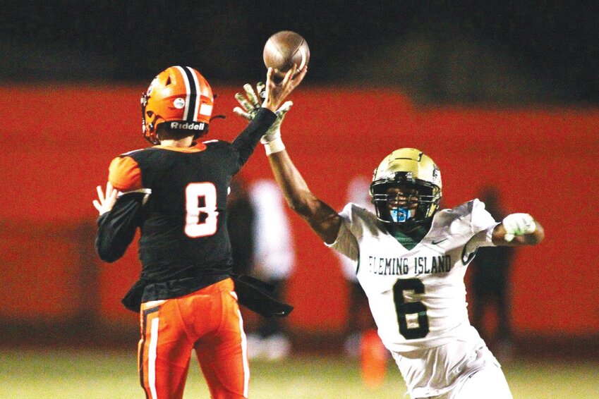 Fleming Island defender Arion Whitt is a hair late in hitting the passing hand of Orange Park quarterback Gabe Taylor in a thrilling season finale won 28-27 by the Eagles.