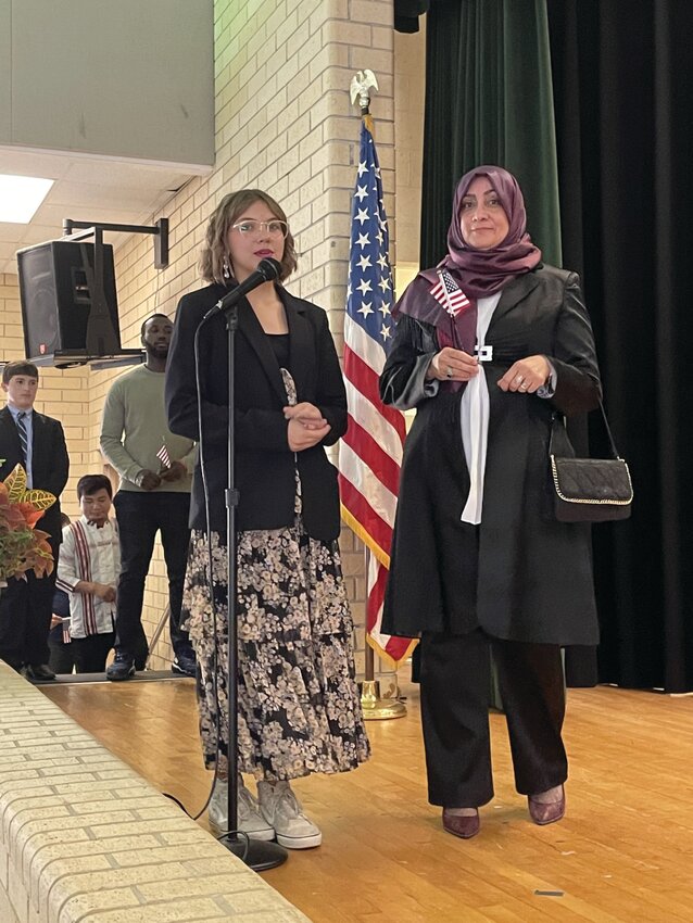 Naturalization candidate Esra Ulukay (right) is paired with a GCSJH student, who announced her name during the ceremony.