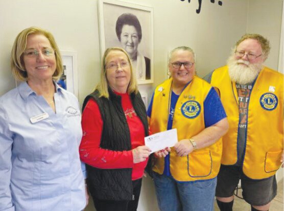 Dave and Celia Vencil of the Orange Park Lions Club drop off a check for $300 to the Clothes Closet and Food Pantry in Orange Park.