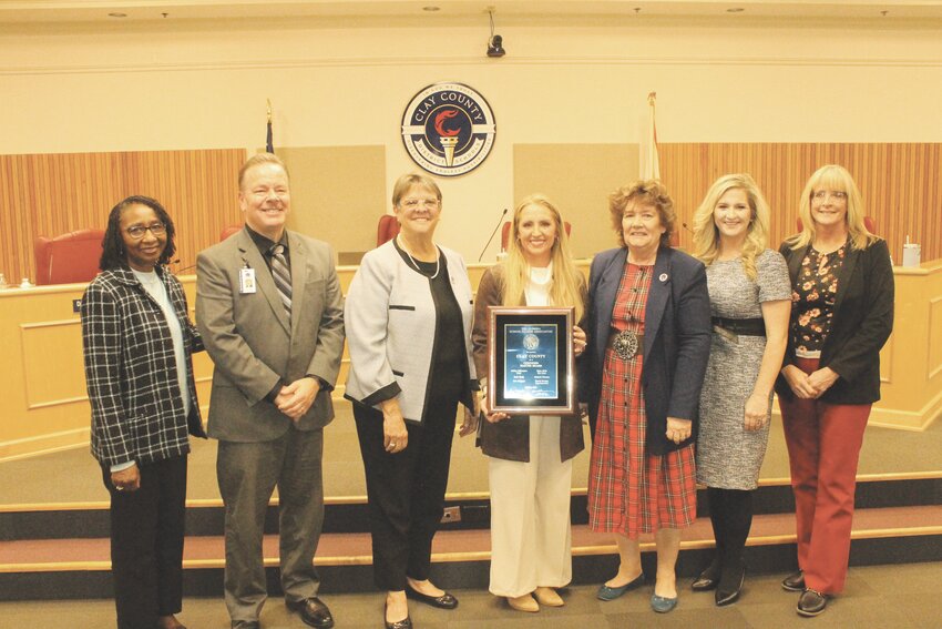 From left, Florida School Board Association Consultant Paula Wright Coles, joins Superindent  David Broski, Mary Bolla, Ashley Gilhousen, Beth Clark, Erin Skipper and Michele Hanson to  celebrate Clay County District Schools earning the Certified Board Status.