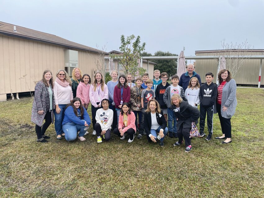 Principal Mallory McConnell, students of the school&rsquo;s gifted class, staff from Pat&rsquo;s Nursery and garden club members planted a red maple tree at Fleming Island Elementary on Arbor Day.