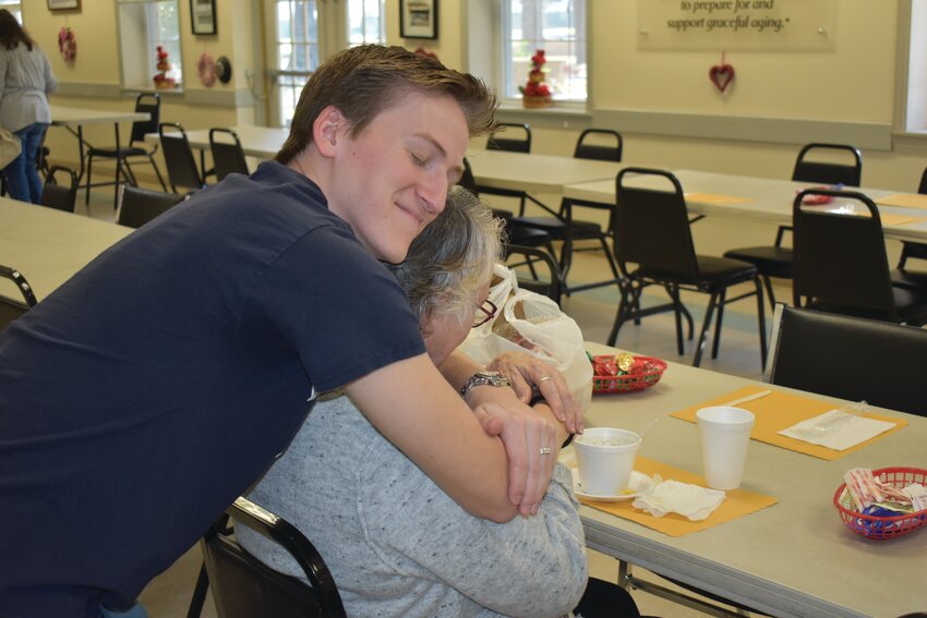 Volunteer Ben Woods gave a woman a much-needed hug of encouragement and compassion after she finished her meal.