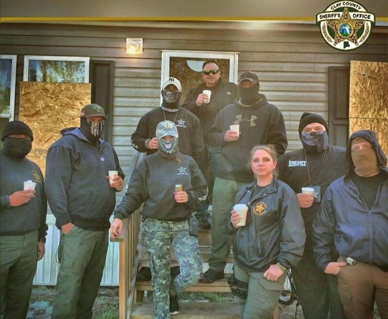 Officers from the Clay County Sheriff's Office pose for the camera after a drug bust.