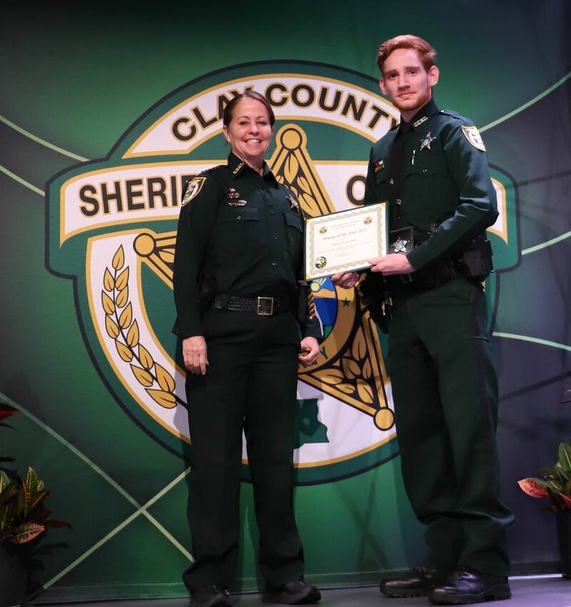 Sheriff Michelle Cook joins Deputy of the Year Charles Smith.