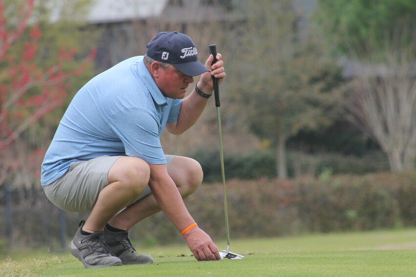 A golfer lines up his shot.