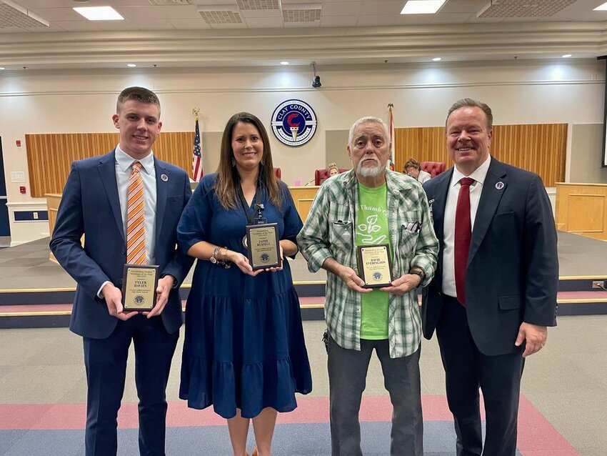 From left, Orange Park High's Tyler Davies, Middleburg High's Jaime Russell and Doctors Inlet Elementary's David Everington join Superintendent David Broskie after being selected as the District's Volunteers of the Year.
