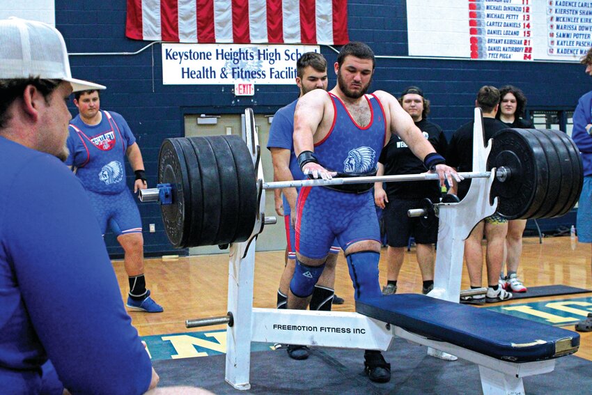 Keystone Heights High's weightlifting team accrued a massive 111 out of a possible 120 team points to win both the Olympics and Traditional District 7-1A titles Friday morning led by senior defending state champion Trey Jeffries, here about to attempt a 380-pound bench press. Keystone Heights is attempting to win a fourth straight state title as regions are scheduled for Saturday at Suwannee High School.