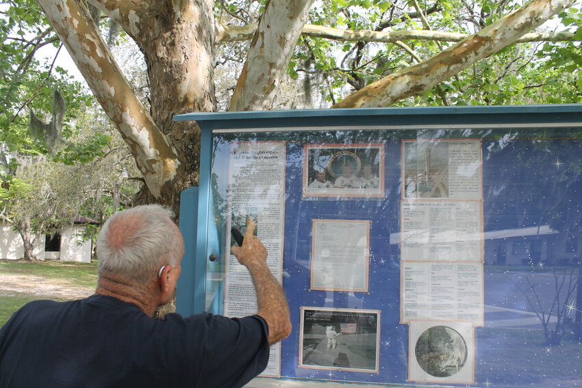 Bob Byrnes pointing to the display board in front of the Moon Tree.