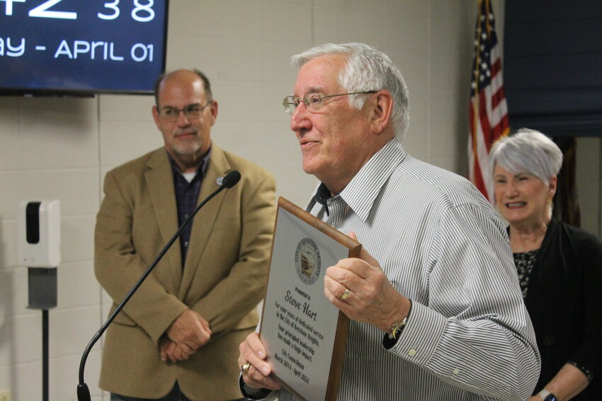 Keystone Heights City Councilman Steve Hart receives a plaque as a token of appreciation on his last day April 1 after serving on the city council for a decade.