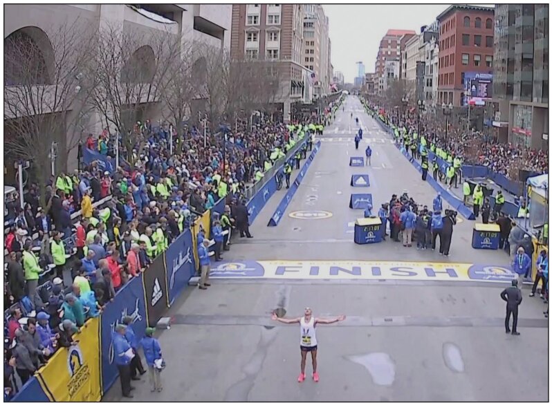 Enoch Nadler absorbs the energy at the finish line of the Boston Marathon after finishing in 22nd place.