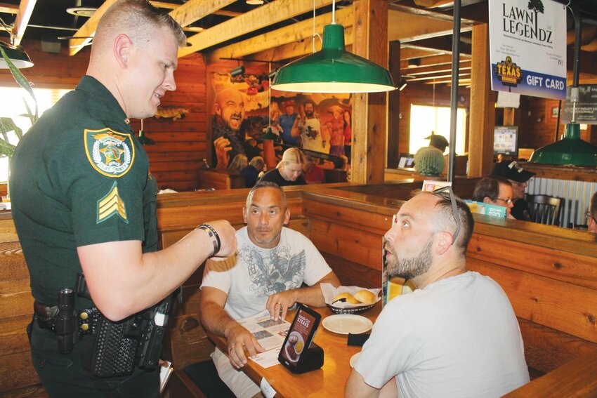 CCSO Sgt. Zach Cox talked with Texas Roadhouse customers last year during the annual Tip-A-Cop event.