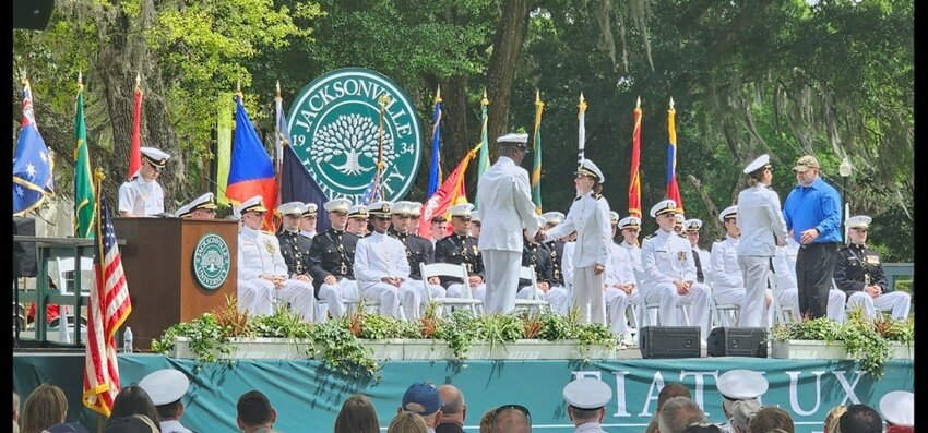 Ridgeview High graduate Samantha Collins accepts her commission as an Ensign in the U.S. Navy.