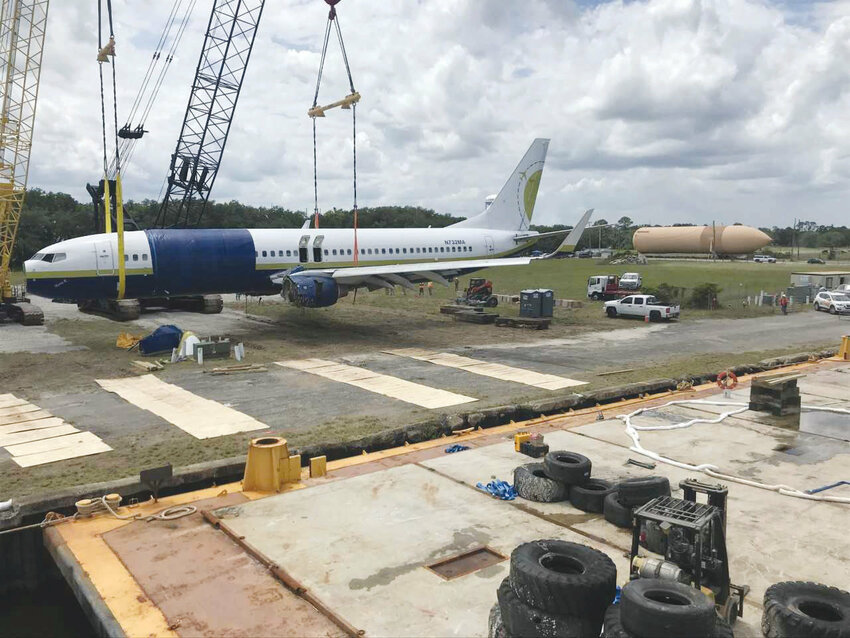 Green Cove Springs&rsquo; MOBRO Marine hoisted the Miami Air jet from the St. Johns River five years ago. In the background is another one of the company&rsquo;s projects &ndash; a space shuttle external fuel tank.