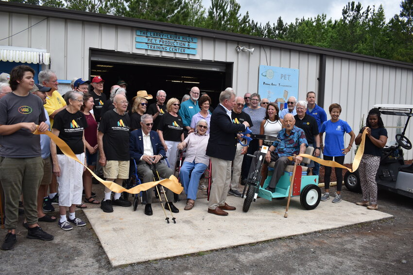 Rotary District 6970 Gov. John Tabor cut the ribbon to re-open the PET Florida shop at Penney Farms, which now includes a new powder-coating machine.