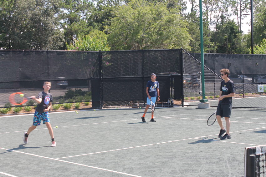 Young players practice their rallies during the Eagle Harbor Tennis Club Junior Summer Camp.
