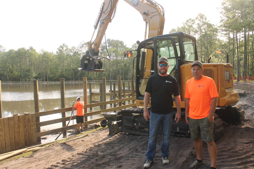 Tyler and Kyle Giebeig, co-owners of Brothers Marine Construction, stand in front of the Ronnie Van Zant Memorial Park construction site.