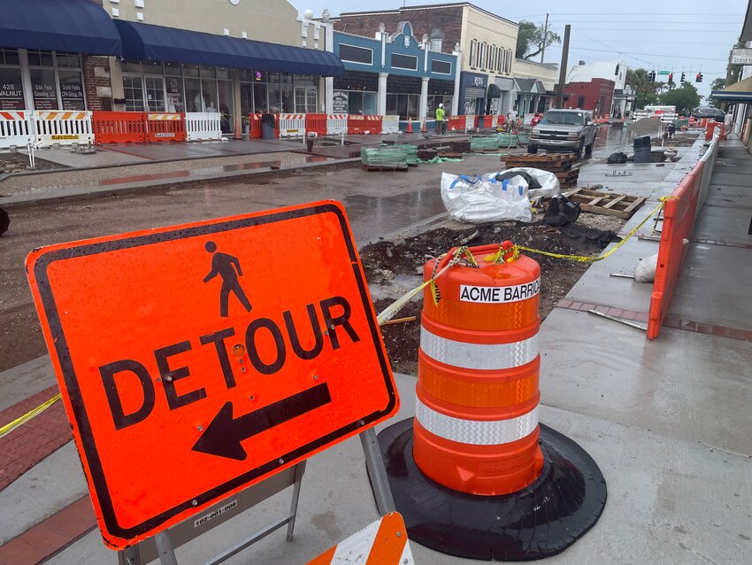 Walnut Street is still accessible to pedestrians during the renovations. Pedestrians still have a narrow sidewalk on either side of the street, enclosed within orange and white barricades.