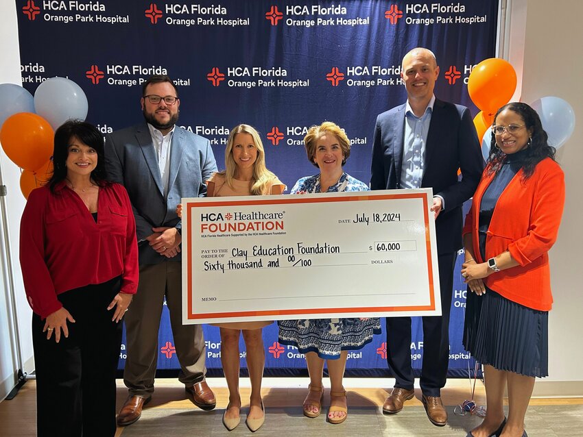 The Clay Education Foundation receives a $60,000 check, the first of three payments, from HCA Florida Orange Park Hospital.